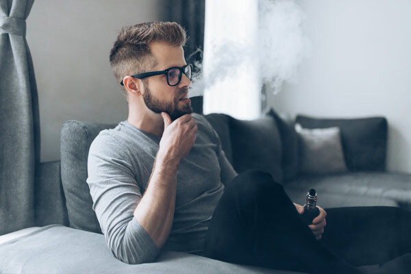 Man Sitting Down Vaping